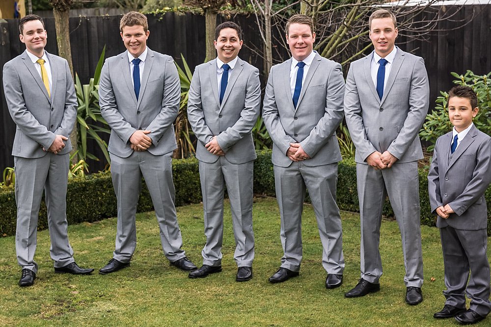 line up photo of the groomsmen and the page boy at a Christchurch Wedding