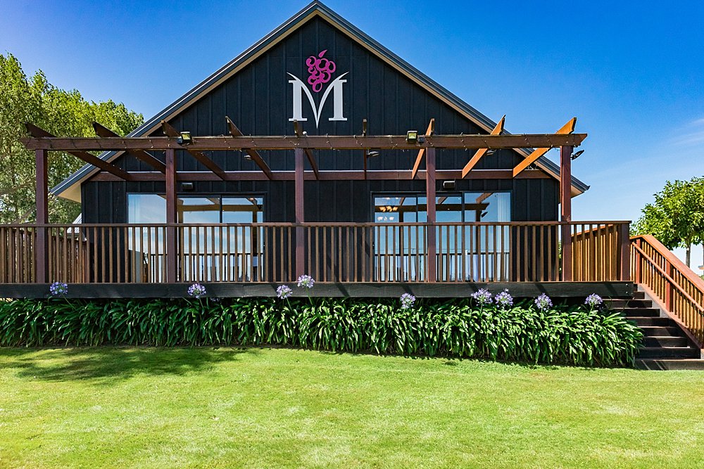 Main deck with a venue brand on the side of the wall at Melton Estate Wedding Venue, Christchurch