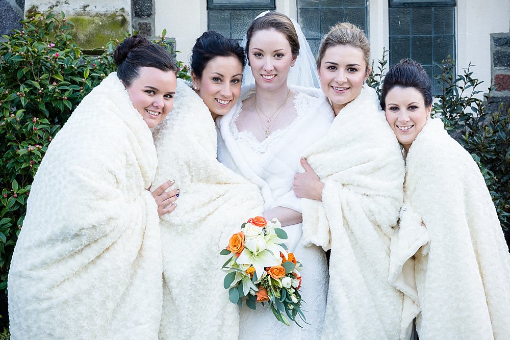 Melton Estate Wedding-bridesmaids huddled to keep warm during winter wedding