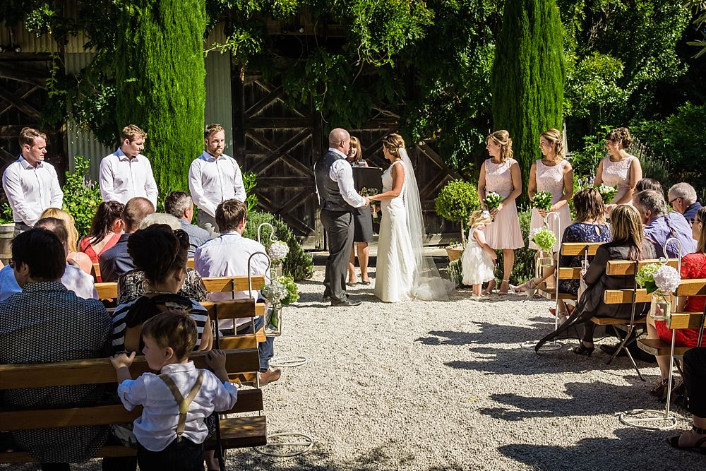 Wedding ceremony in courtyard at Cossars Wineshed wedding venue