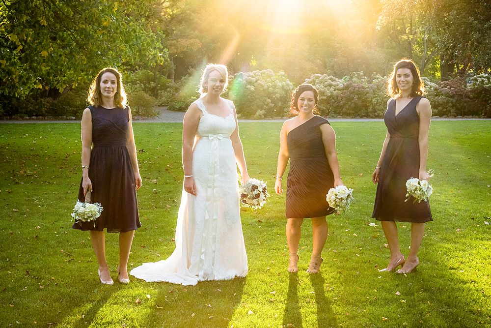 Bride and bridesmaids in late warm afternoon sun at Botanical Gardens