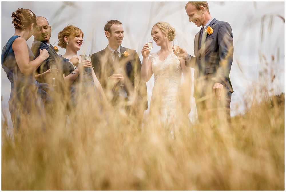 Tipapa Woolshep Wedding Bridal party drinking wine shot through long dry grass